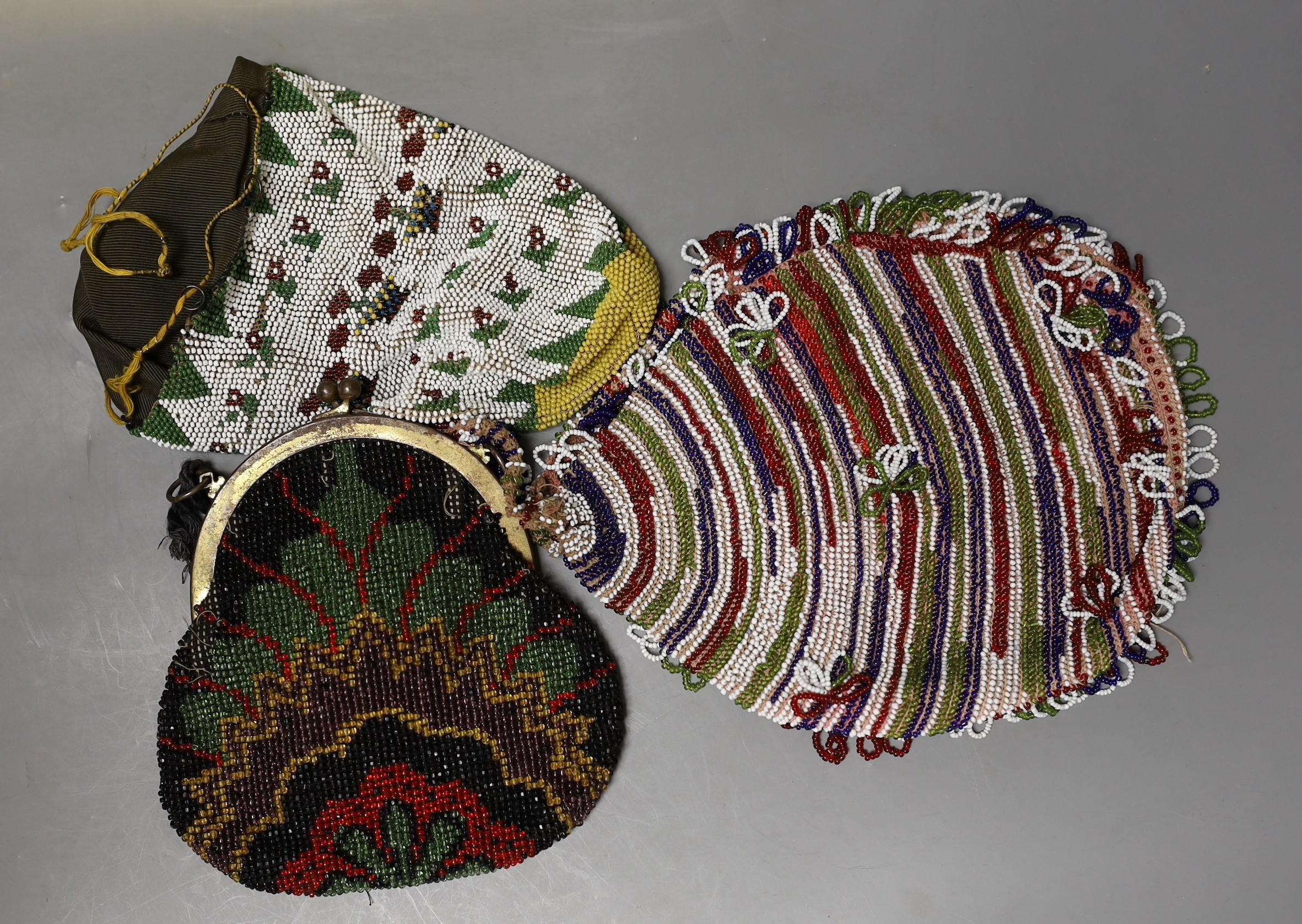 A collection of beadwork purses and bags from early 1900’s, including a W W I bead-worked purse dated 1916 with a steel frame surmounted with a building as the clasp, three beadwork bible bags, five beadwork purses and a